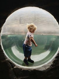 Full length of boy standing in water