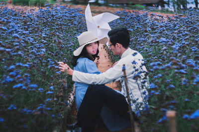 Rear view of couple holding hands