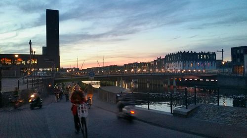 People in city at dusk