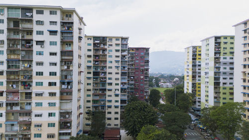 Residential buildings in city against sky