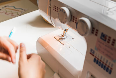 Woman's hands using sewing scissors