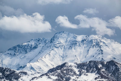 Mountain peaks covered with snow. scenic view of snow covered mountains against sky