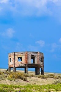 Old ruin on field against sky