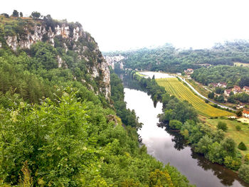 High angle view of river amidst trees against sky