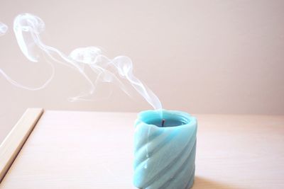 Close-up of turned off candle on table