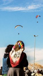 Person paragliding against sky