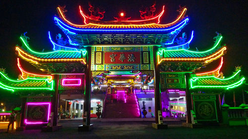 Multi colored illuminated sign at night