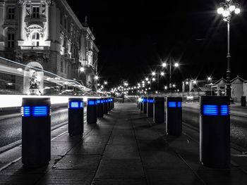 View of illuminated street lights at night