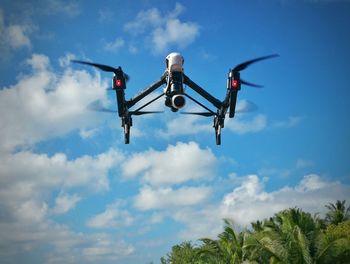 Drone with camera against sky