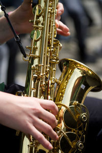 Cropped image of street performer playing saxophone
