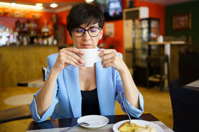 Young woman drinking coffee at home