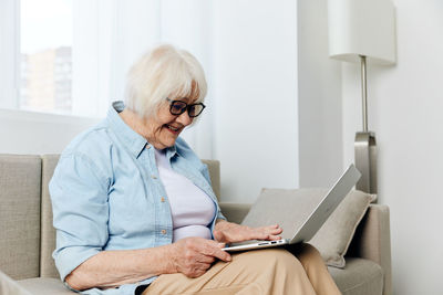 Doctor using laptop while sitting at home