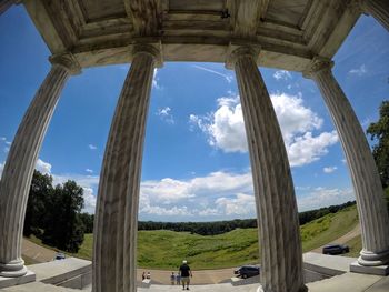 Panoramic view of people seen through archway