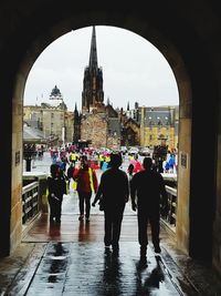 Rear view of people walking in rain