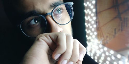 Close-up of thoughtful man wearing eyeglasses