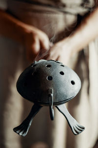 Woman with incense bowl and feather