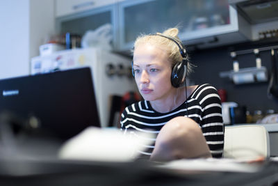 Businesswoman using laptop while sitting at home