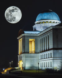 Low angle view of illuminated building against sky at night