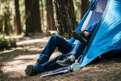 Man sitting in tent on field