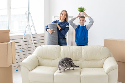 Portrait of mother and son standing at home