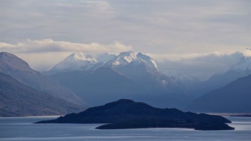Scenic view of lake and mountains against sky