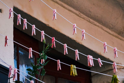 Low angle view of clothes line with line of pink clothes pin