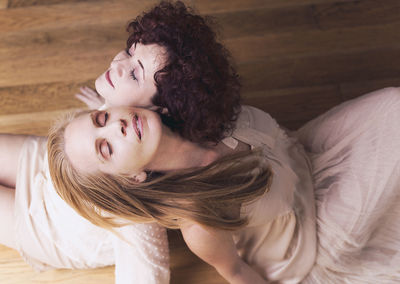 High angle view of young woman lying on bed at home