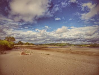 Scenic view of landscape against cloudy sky