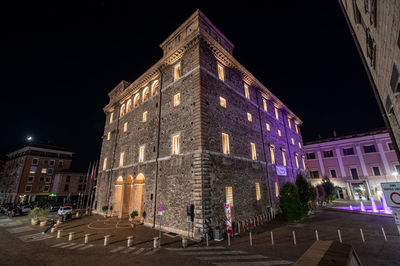 Low angle view of illuminated building at night