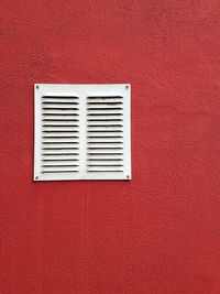 Close-up of window on red wall