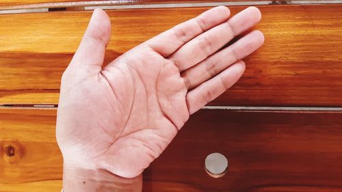 Close-up of hand holding table