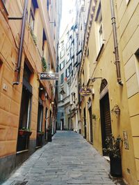 Empty alley amidst buildings in city