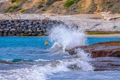 Waves splashing on rocks at shore