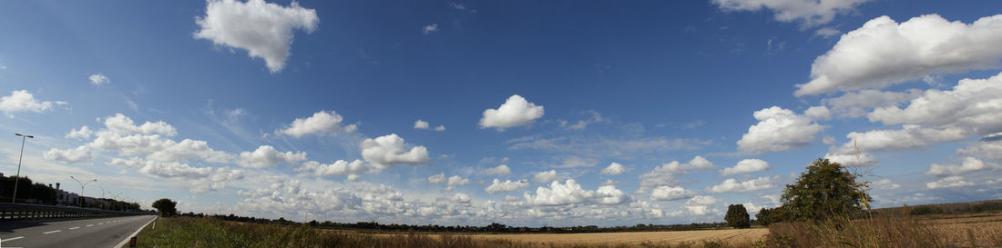 Panoramic view of country road against cloudy sky