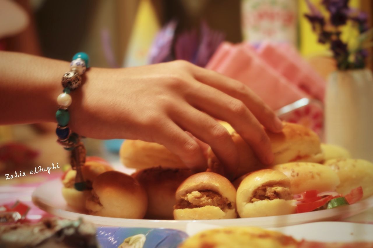 person, holding, part of, focus on foreground, cropped, food and drink, indoors, tradition, food, freshness, lifestyles, human finger, close-up, selective focus, midsection, unrecognizable person