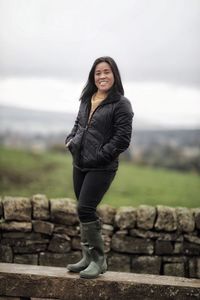 Portrait of a smiling young woman standing outdoors