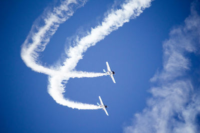 Low angle view of airplane flying in sky