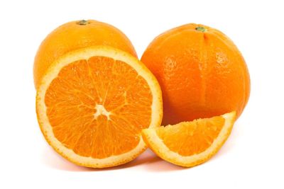 Close-up of orange fruit against white background