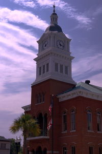 Low angle view of clock tower against sky