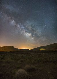 Scenic view of field against sky at night