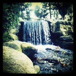 Scenic view of river flowing through rocks