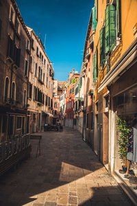 Empty alley amidst buildings in city