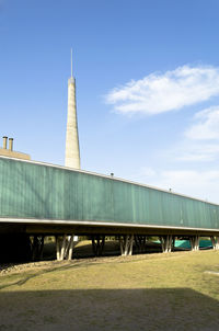 Pier by tower against sky