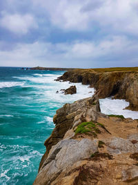 Scenic view of rocks on beach against sky