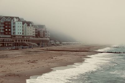 Scenic view of beach against sky during winter