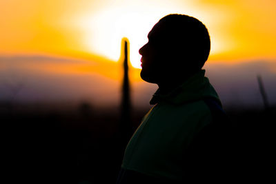 Portrait of silhouette man standing against sky during sunset