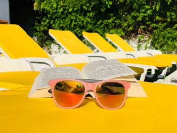 Close-up of sunglasses and book on table