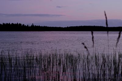 Scenic view of lake against sky at sunset