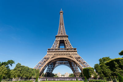 Low angle view of tower against blue sky