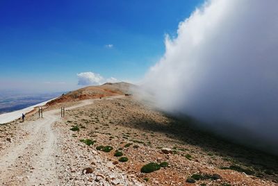 Scenic view of mountain against cloudy sky